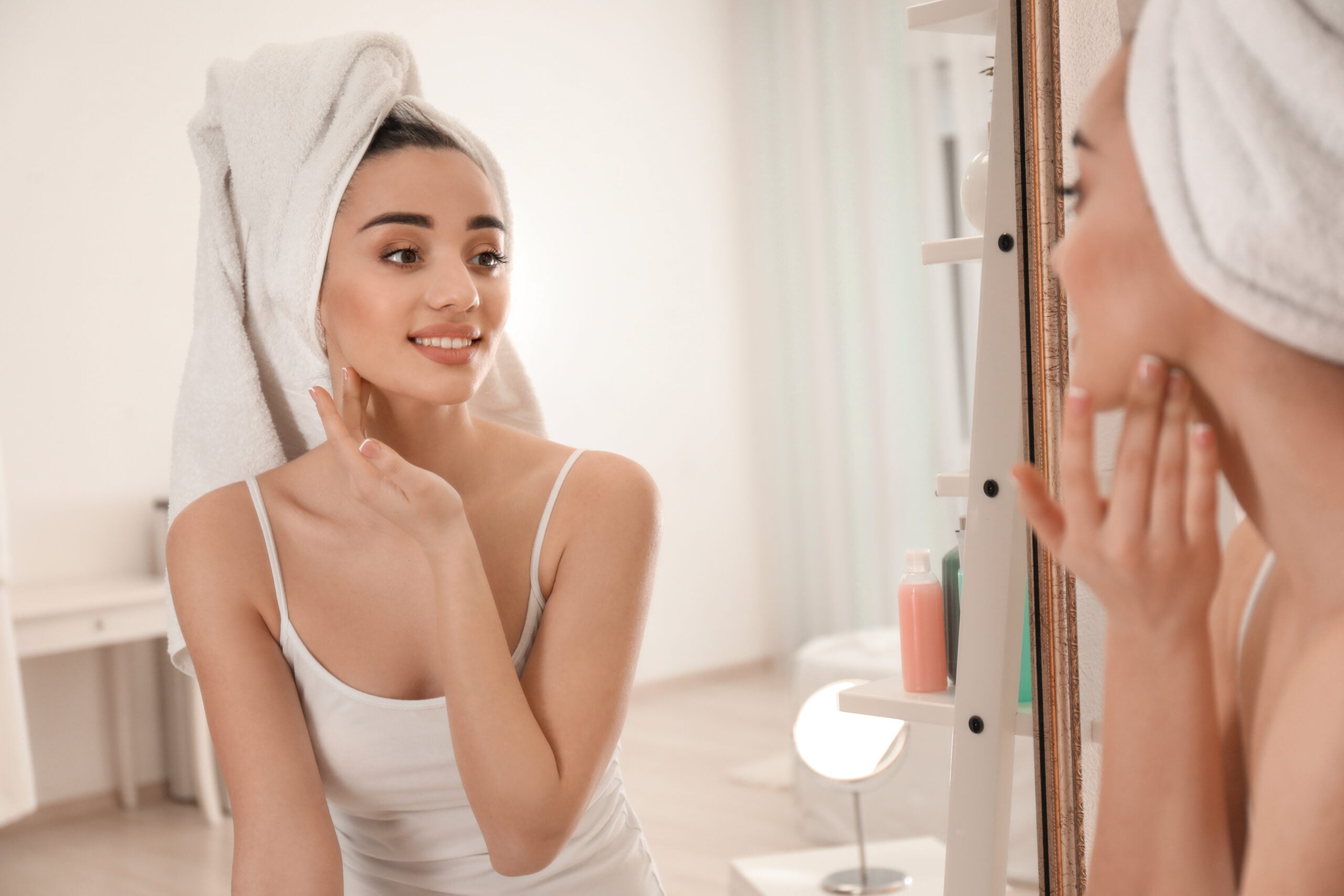 Beautiful woman near mirror in morning